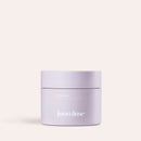 Lilafarbene Körperpflege 2in1-Aha-Body-Scrub steht vor hellem Hintergrund.