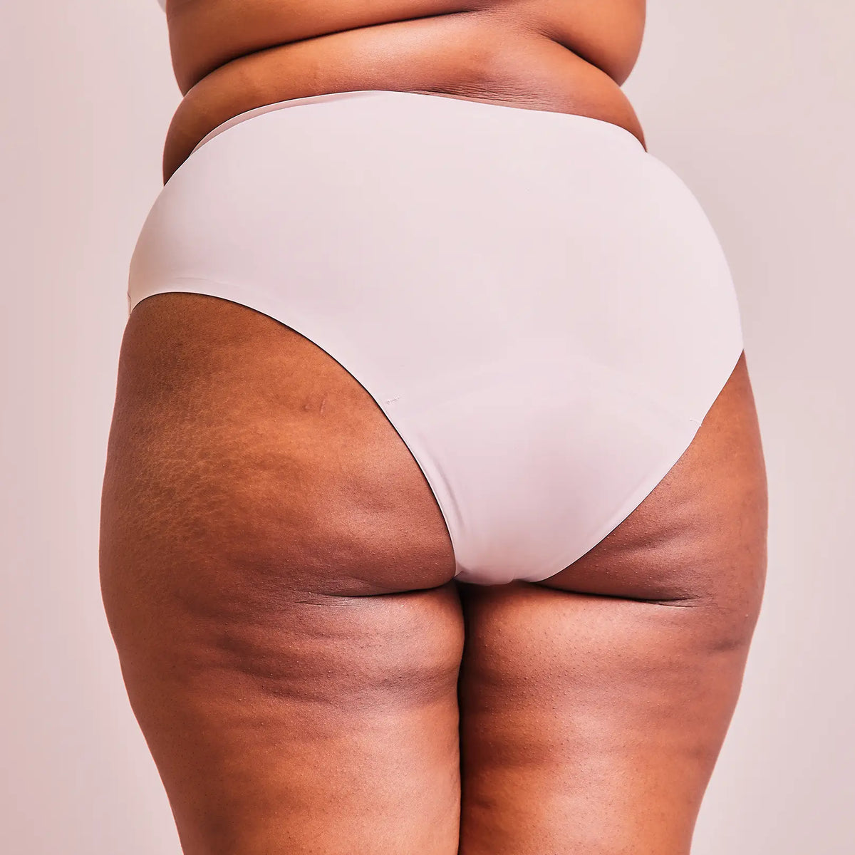 Woman wearing the Seamless Slip period panty in nude