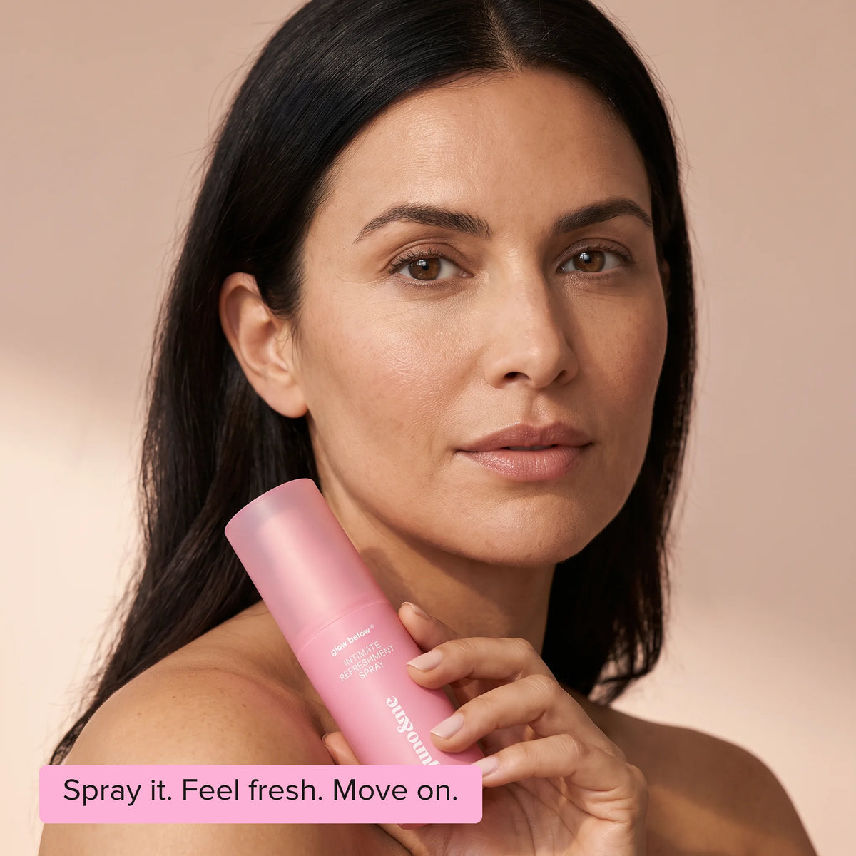 Intim Deo by juno&me standing in pale sand in front of a pink wall, Spray it. Feel fresh. Move on.