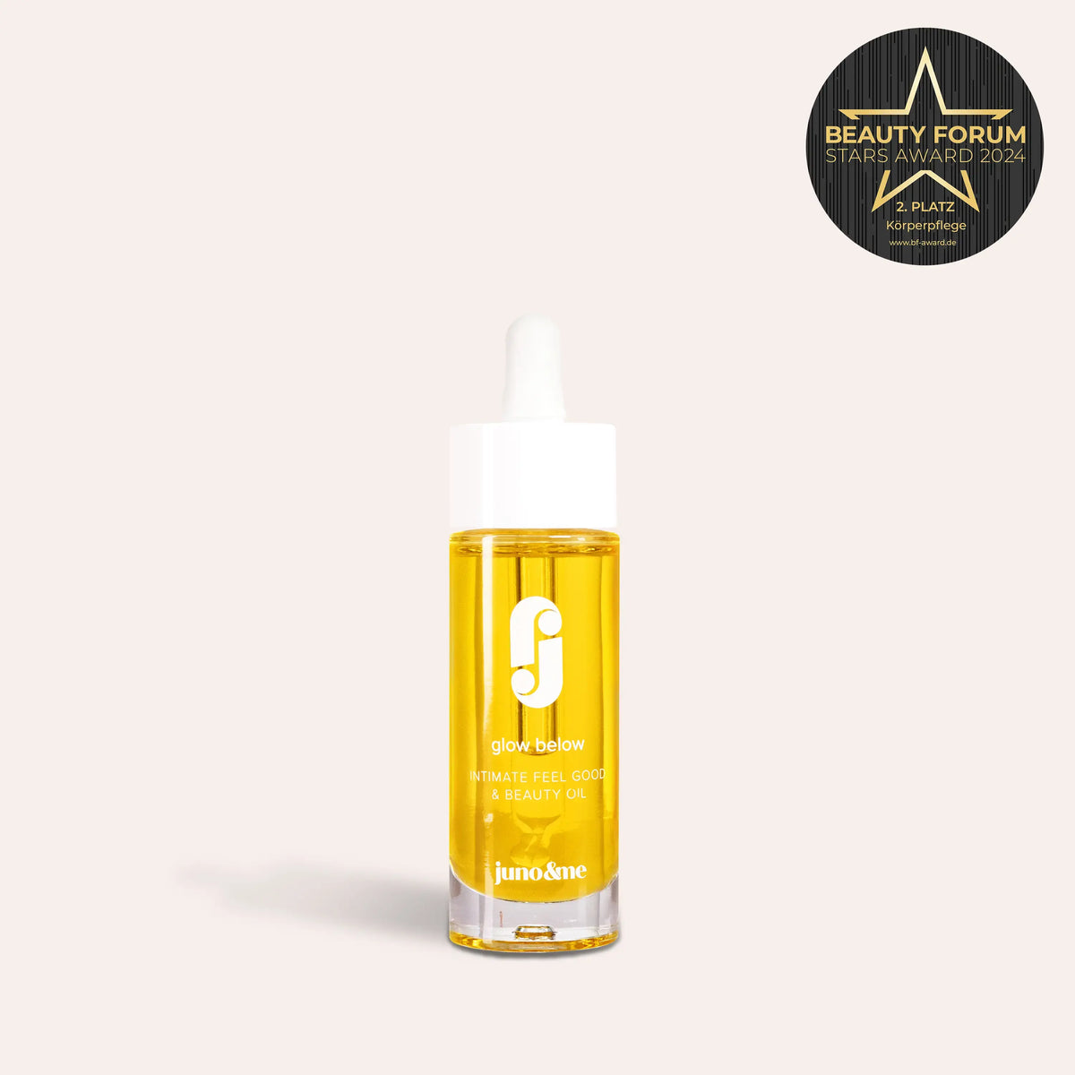 Glow Below Oil standing upright, with the Beauty Forum Award alongside