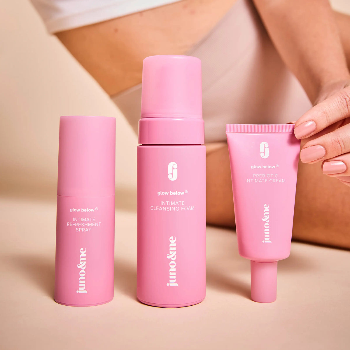 Three intimate care products in the foreground, a person sitting behind them
