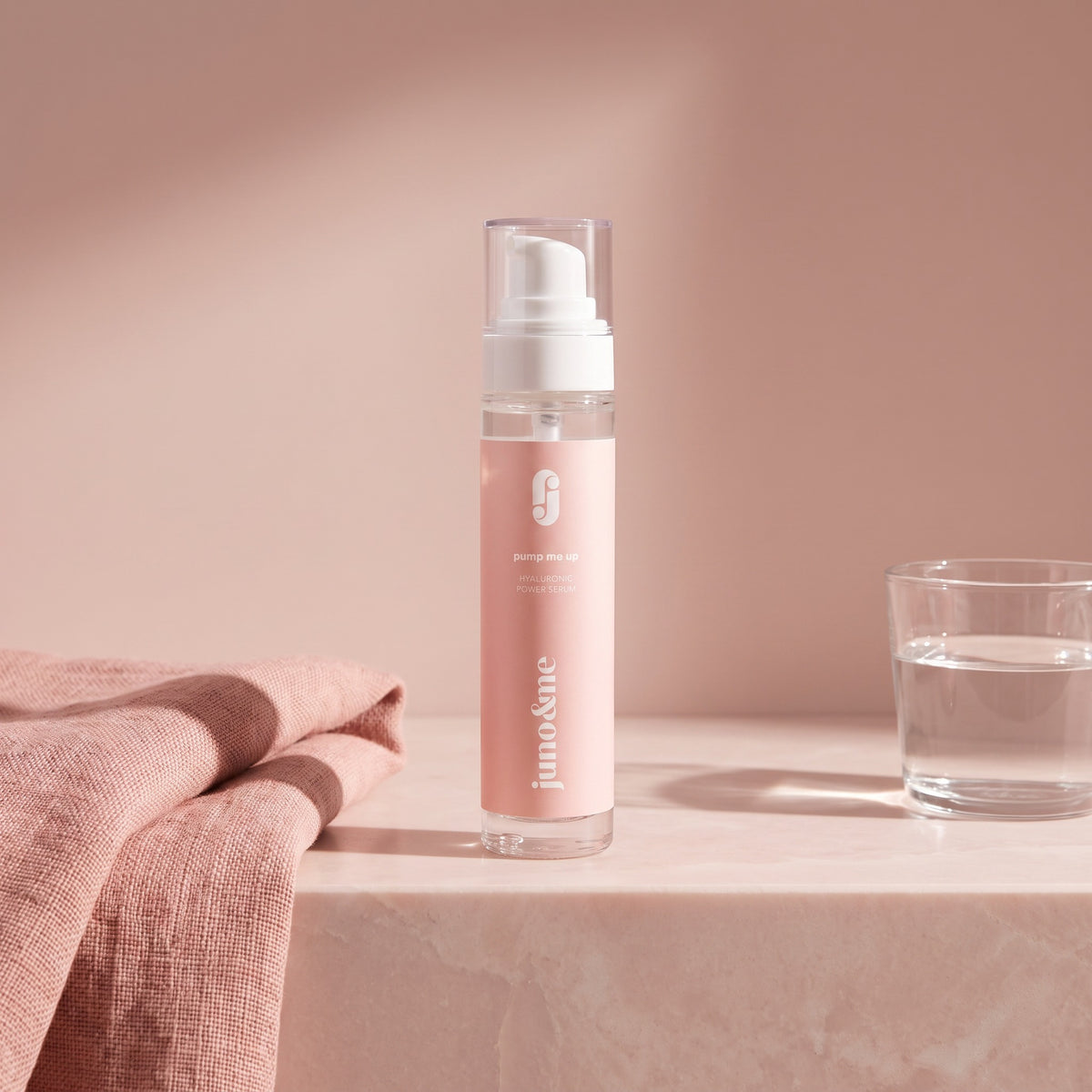 Décolleté Serum on a bathroom shelf next to a towel